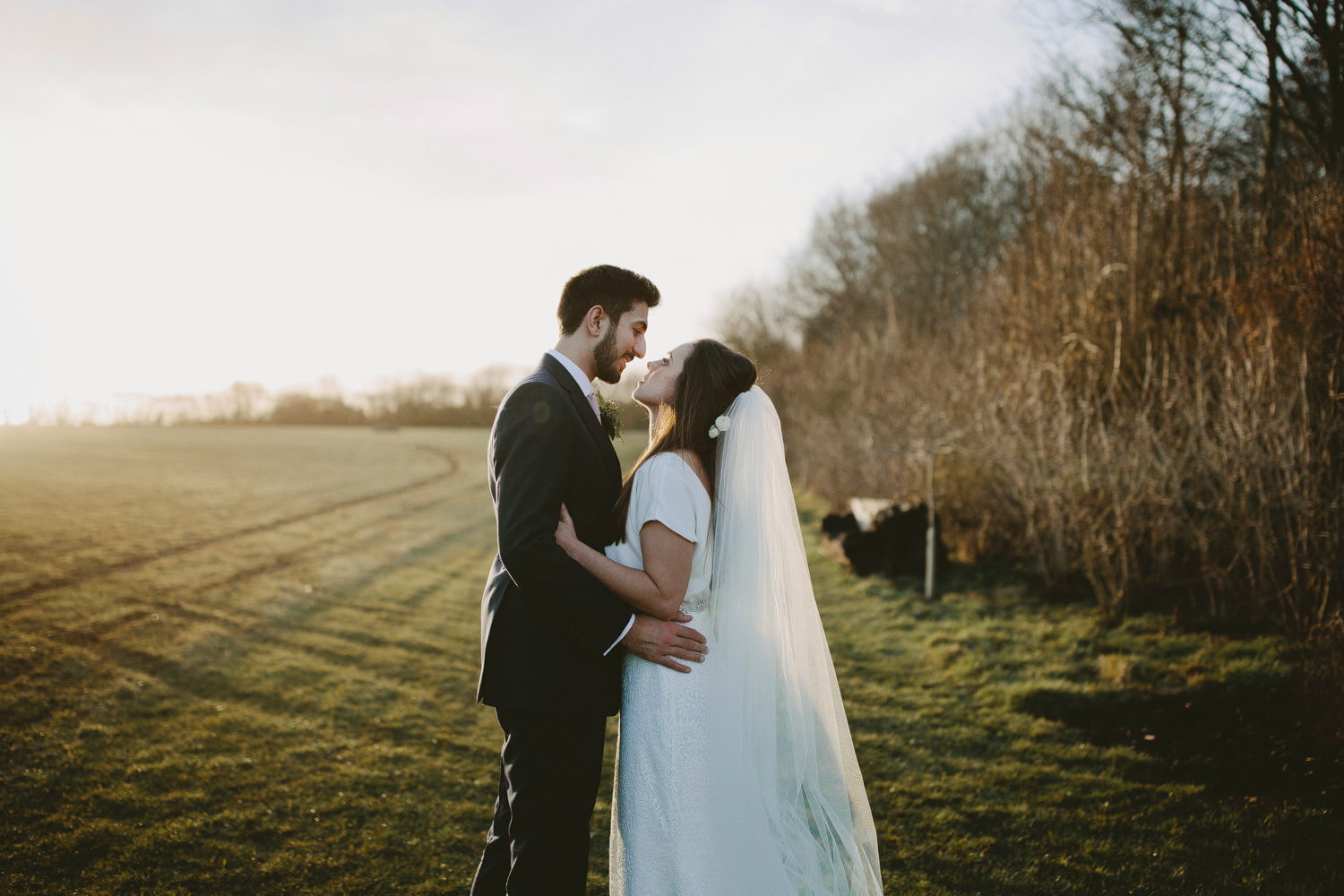 Bride and groom look at each other outside during a Cripps barn wedding