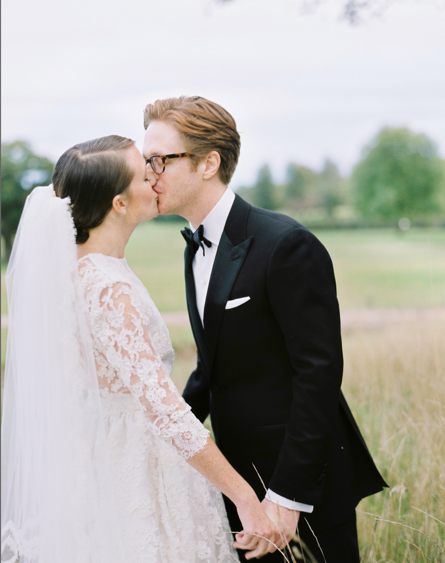 groom in black tie kissing bride